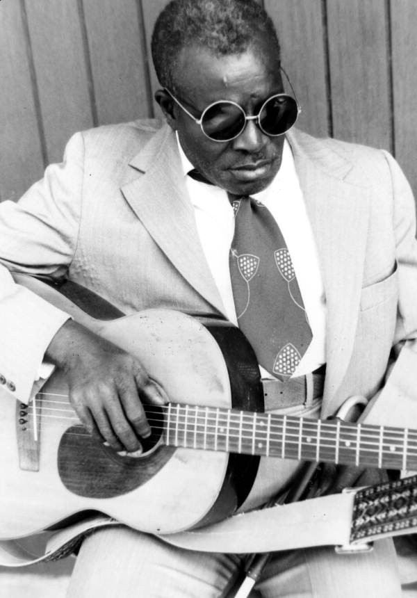Rev. N.L. Williams playing gospel music for a field tape.