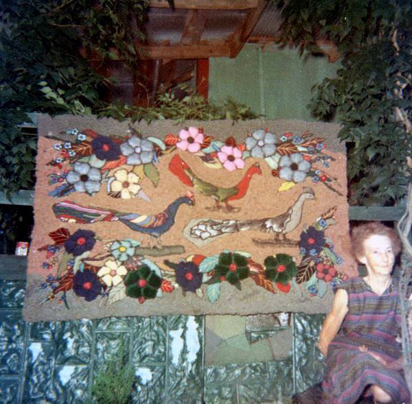 View showing rugmaker Blanche McDonald with the rug she made.