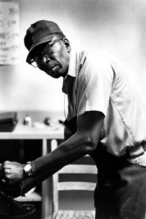 Shoe shiner Frank Mitchell working at Cappell's Shoe Shop in Lake City, Florida.