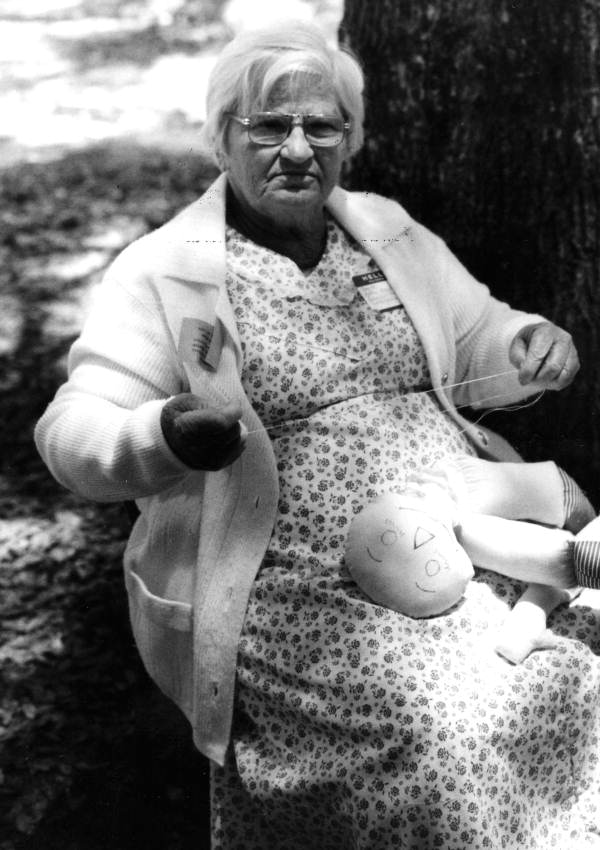 Dollmaker Bertha Burnham demonstrating dollmaking at the 1979 Florida Folk Festival in White Springs, Florida.