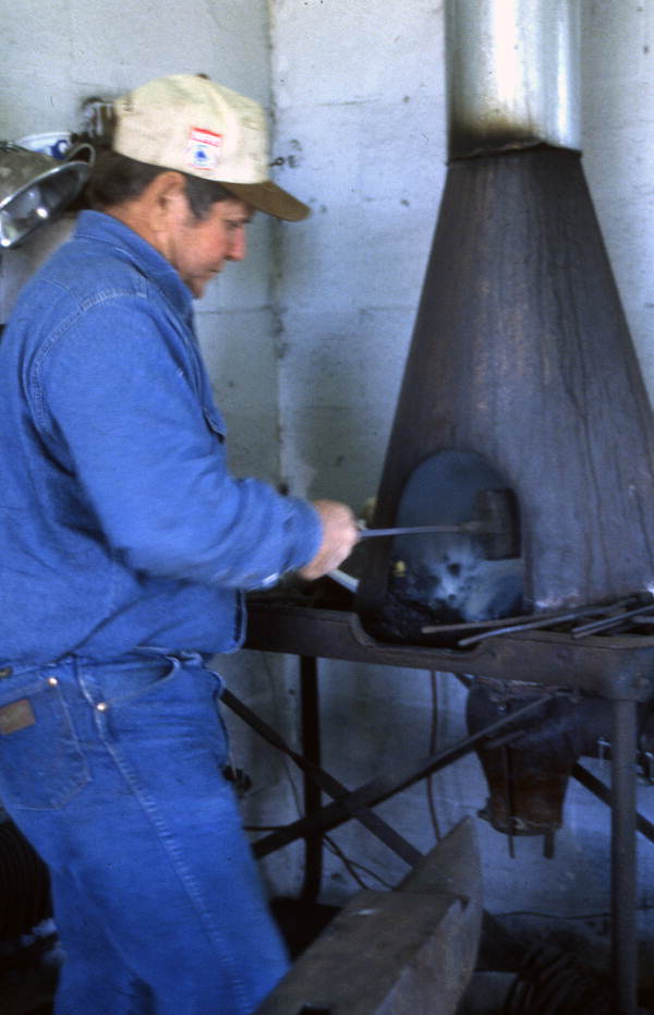 Randy Minger at furnace blacksmithing horseshoes at the Spring Garden Ranch Training Center in De Leon Springs, Florida.