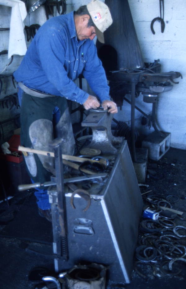 Farrier Randy Minger working on a horseshoe at the Spring Garden Ranch Training Center in De Leon Springs, Florida.