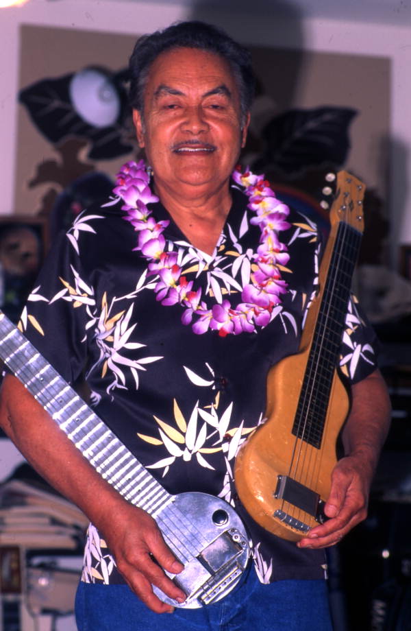 Portrait of Hawaiian steel guitarist Richard "Dick" Sanft with a couple of guitars at his residence in Kissimmee, Florida.