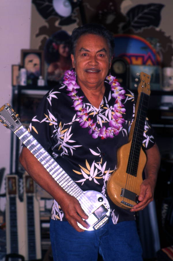 Portrait of Hawaiian steel guitarist Richard "Dick" Sanft holding two of his guitars at his residence in Kissimmee, Florida.