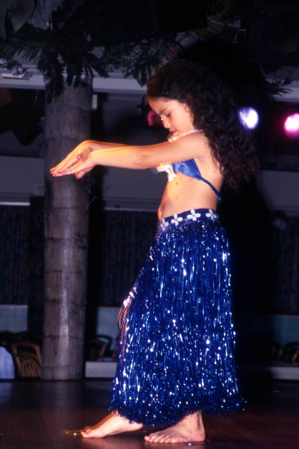 View of a young Polynesian dancer shown during a performance at Sea World in Orlando, Florida.