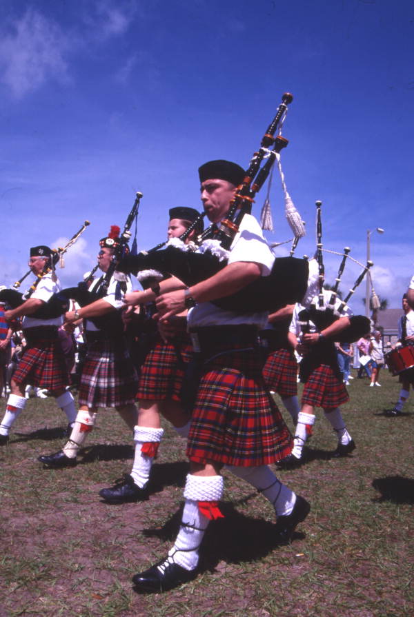 Close-up view showing members of a Scottish pipe band performing at the Highland Games in Dunedin, Florida.