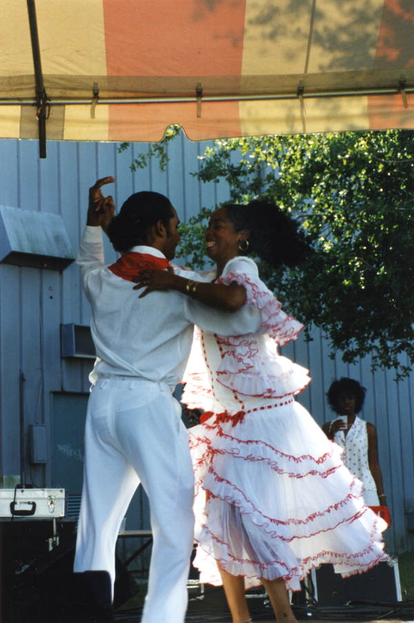 Neri Torres dancing with man during a performance by the Cuban dance and music ensemble Ife-Ile at the Historical Museum of Southern Florida's Harvest Festival in Miami, Florida.