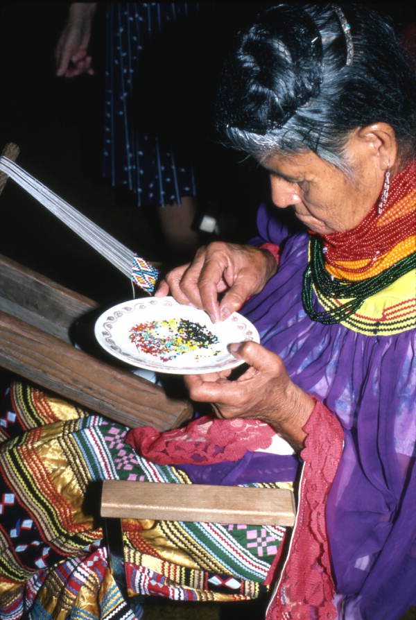 Lottie Shore picking out beads to use on Seminole sash - White Springs, Florida.