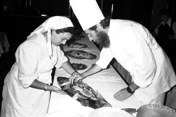 Rina and Baruch Kramer preparing salmon for a bar mitzvah - Miami Beach, Florida.