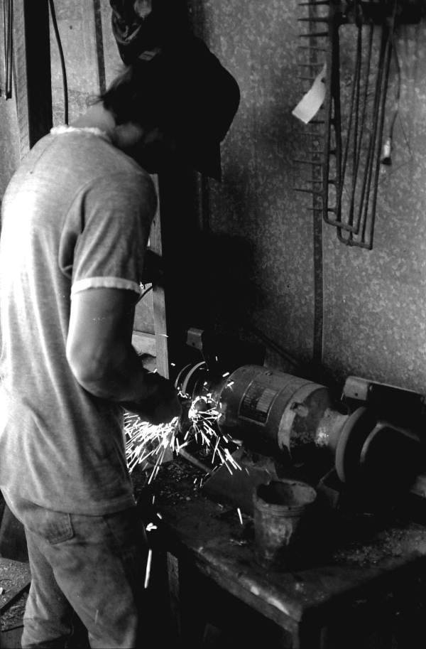 Rodney Richards using power tools to start making oyster tongs- Apalachicola, Florida.