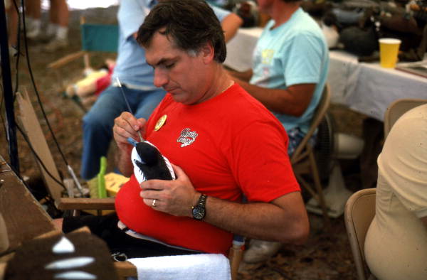 Michael Berg of Jacksonville painting his carved wood duck decoy at the Florida Folk Festival - White Springs, Florida