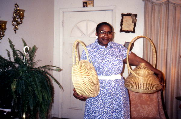 Margaret Garrison showing the sweetgrass baskets she has made - Jacksonville, Florida.