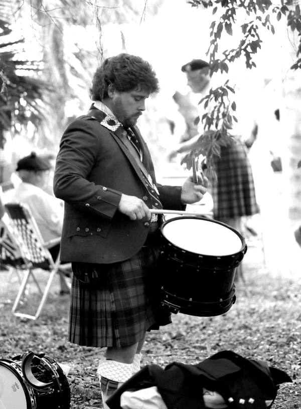 Drummer from a pipe band practicing at a Scottish Games event