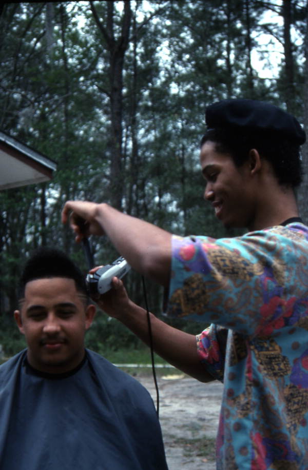 Isaac Moore getting his hair cut and styled by Teddrick Moore- White Springs, Florida