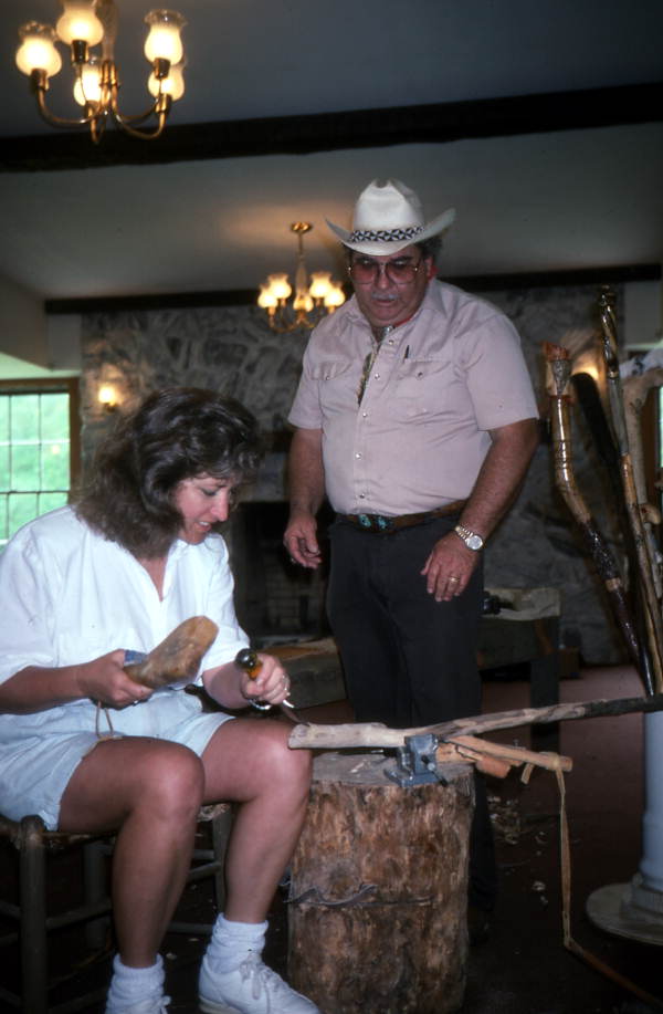Bobby Johns watching a woman carve wood at a cane making workshop- White Springs, Florida