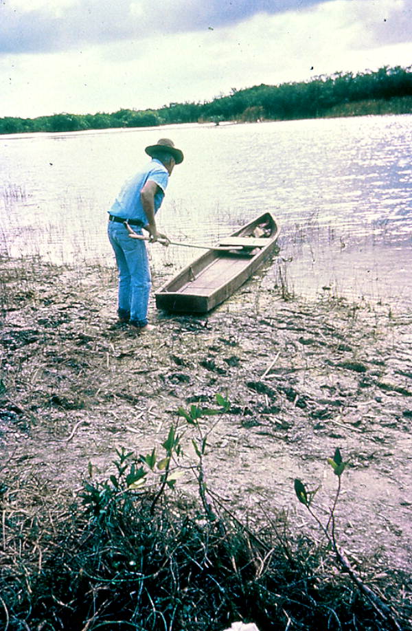 Glen Simmons pushing his glades skiff boat into the water.