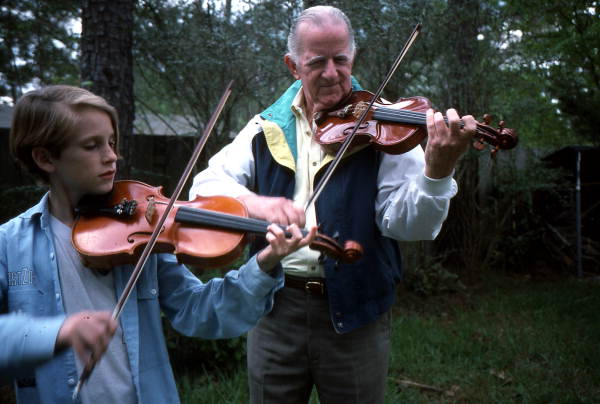 Teacher George Custer and his grandson and apprentice Andrew Cook playing the fiddle- Gainesville, Florida