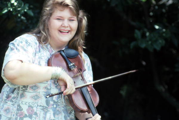 Amy Cox laughing while playing the fiddle- Fort Lauderdale, Florida.
