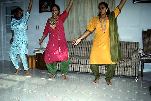 Nila Radhakrishnan (in red) teaching apprentices Prema Menon (L) and Priya Menon East Indian dance- Dade City, Florida