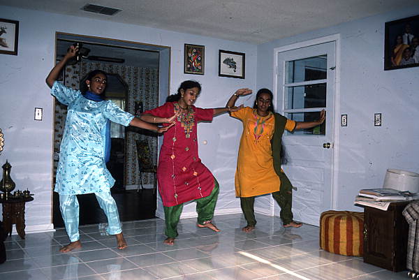 Nila Radhakrishnan (in red) teaching apprentices Prema Menon (L) and Priya Menon East Indian dance- Dade City, Florida