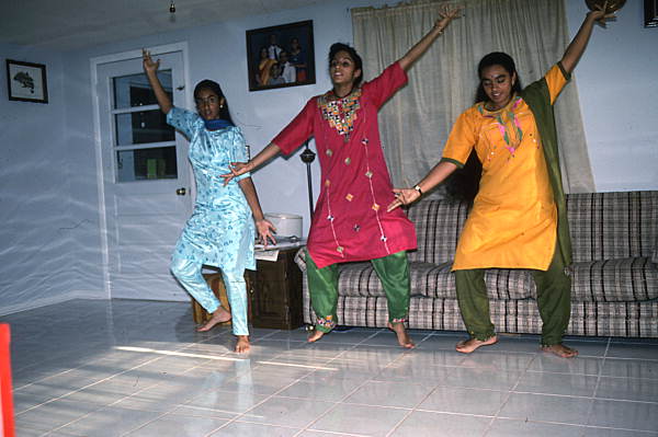 Nila Radhakrishnan (in red) teaching apprentices Prema Menon (L) and Priya Menon East Indian dance- Dade City, Florida