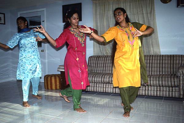 Nila Radhakrishnan (in red) teaching apprentices Prema Menon (L) and Priya Menon East Indian dance- Dade City, Florida