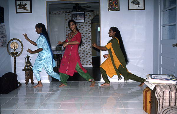 Nila Radhakrishnan (in red) teaching apprentices Prema Menon (L) and Priya Menon East Indian dance- Dade City, Florida