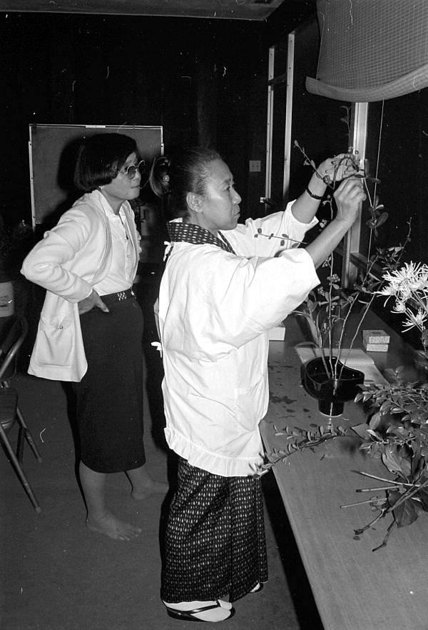 Sumino McGlamory observes as Atsuko Lefcourte makes Ikebana floral arrangement- Palm Beach, Florida.