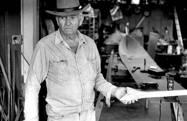 Glen Simmons holding a piece of wood that is part of his Everglades skiff- Florida City, Florida.