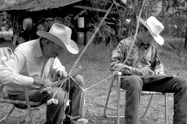 Cow whip maker George "Junior" Mills (l) and his apprentice J. Taylor Marcus working - Okeechobee, Florida.