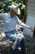 Cow whip maker George "Junior" Mills working on whip - Okeechobee, Florida.