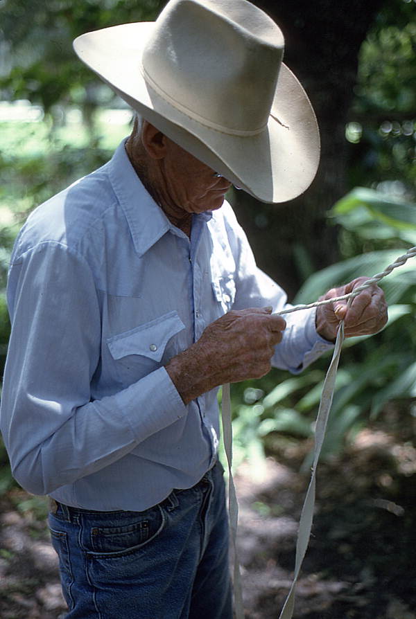 Cow whip maker George "Junior" Mills plaiting a whip - Okeechobee, Florida.