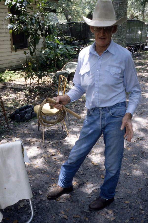 Cow whip maker George "Junior" Mills holding whip - Okeechobee, Florida.