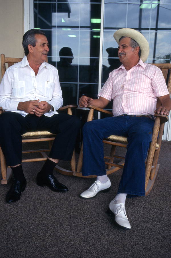 Cuban guajiro singer Meliton Perdomo, right, listens as his apprentice, Mario Brito, sings a decima - Medley, Florida.
