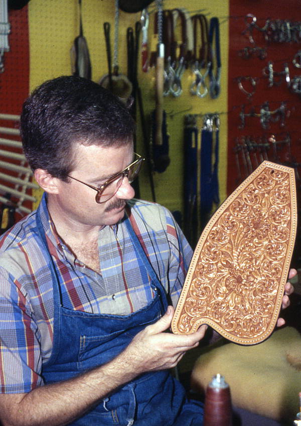 Saddlemaker Perry McLelland with tooled saddle part - Lake Worth, Florida.