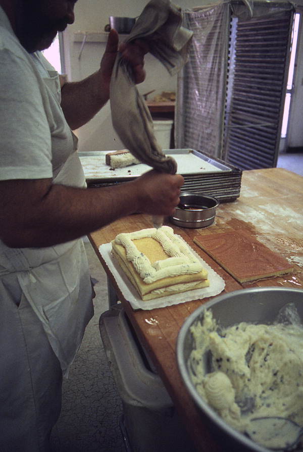 Baker Mike Caforio filling sponge cake with cheese - Lake Worth, Florida.