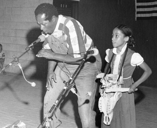 Banjoist and bones player Abner Jay performs with unidentified child at the Florida Folk Festival - White Springs, Florida