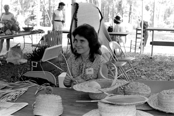 Pam Solano of St. Augustine demonstrating palmetto hat braiding at the 1986 Florida Folk Festival - White Springs, Florida