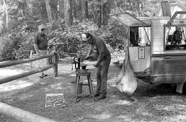 Farrier John Flaherty working on a horseshoe at the 1988 Florida Folk Festival - White Springs, Florida