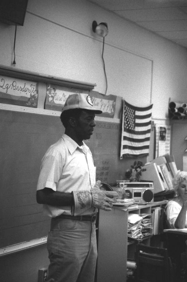 Man showing students protective gear used in harvesting sugarcane - Florida