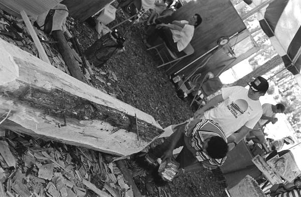 Bobby Henry, center, starting to work on a dugout canoe at the 1988 Florida Folk Festival - White Springs, Florida