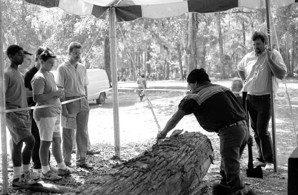 Bobby Henry strips bark from a tree in preparation for making a dugout canoe - White Springs, Florida