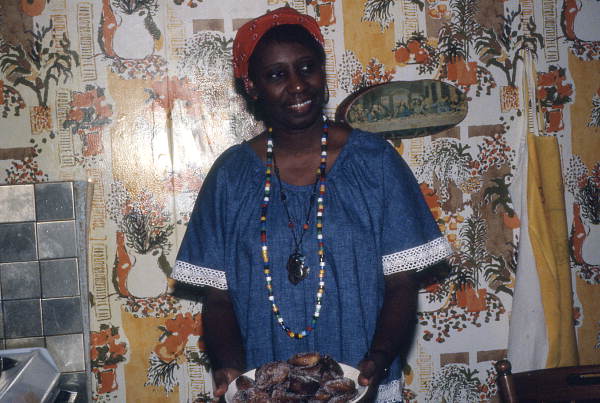 Liliane Louis holding a plate of beignets - Miami, Florida.