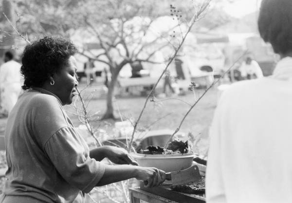 Woman preparing barbecued ribs - Florida.