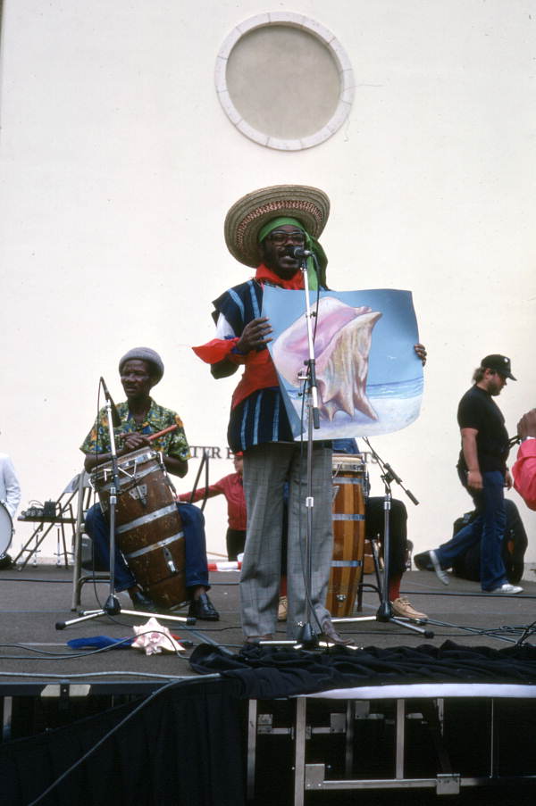Limone Joseph with conch shell painting and drummers at the Traditions Festival - Miami, Florida.