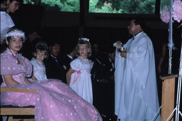 Members of the Quinceanera receive a blessing from the priest - Apopka, Florida