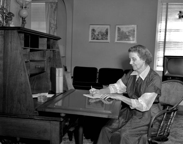 Mrs. Morneweck writing at her desk