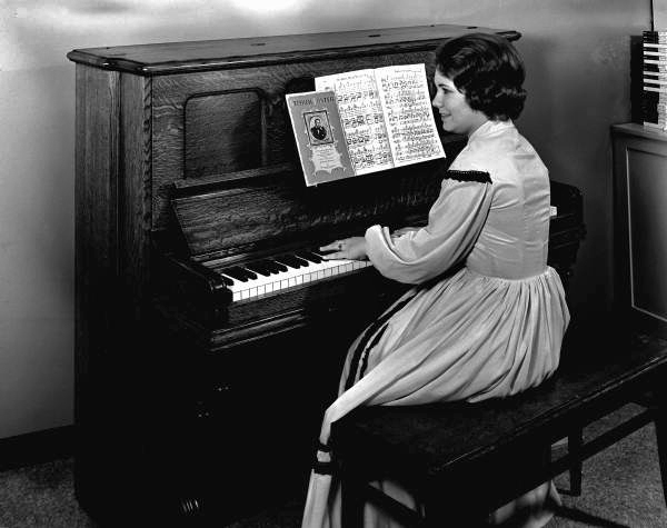 Suzette Cason playing an upright piano at the Stephen Foster Center - White Springs, Florida
