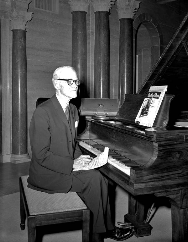 Geoffrey O'Hara sitting at a piano