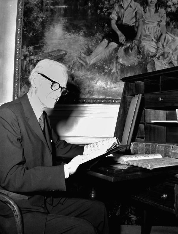 Geoffrey O'Hara reading by desk at the Stephen Foster Memorial Center - White Springs, Florida